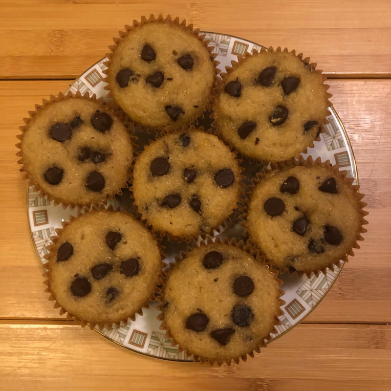 Nut Free Chocolate Chip Muffins on a cute plate with a wood table underneath