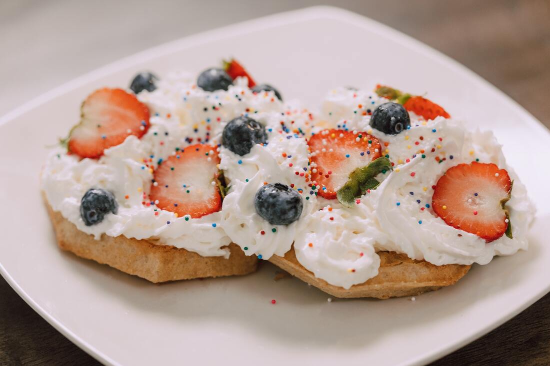Keto Friendly bread with fluffy cream cheese with sliced fruits and sprinkles